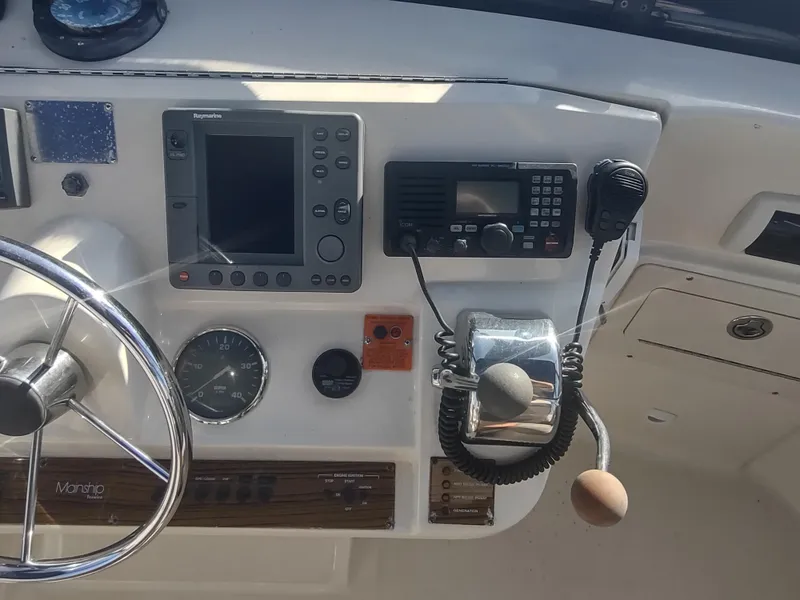 Slide: The Image of 2004 Mainship 400 Trawler helm with navigation equipment and controls. - 46