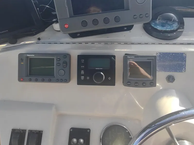 Slide: The Image of Control panel of a 2004 Mainship 400 Trawler with navigation instruments. - 49