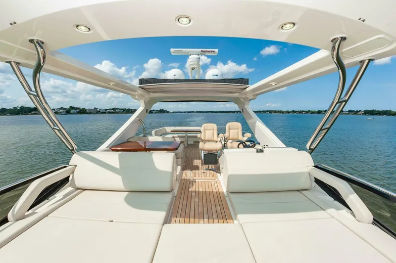 Slide: The Image of Luxurious 2015 Sea Ray L659 Fly yacht interior with spacious seating and scenic water view. - 14