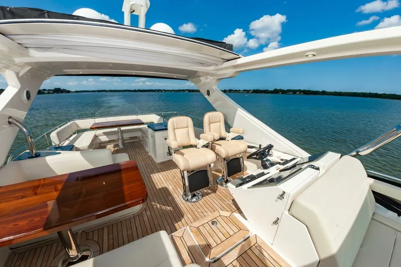Slide: The Image of Luxurious 2015 Sea Ray L659 Fly yacht interior with elegant seating and scenic water view. - 15