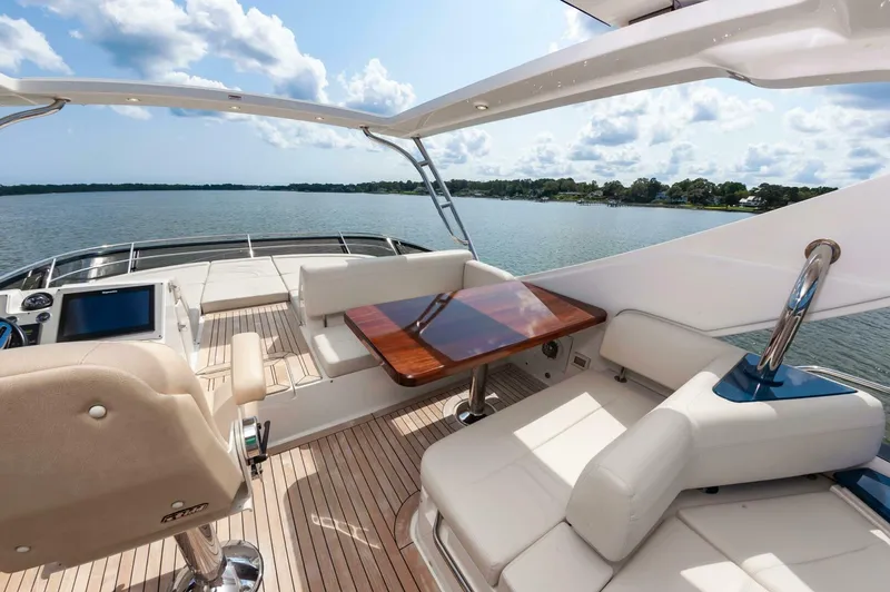 Slide: The Image of Luxurious 2015 Sea Ray L659 Fly yacht interior with elegant seating and scenic water view. - 17