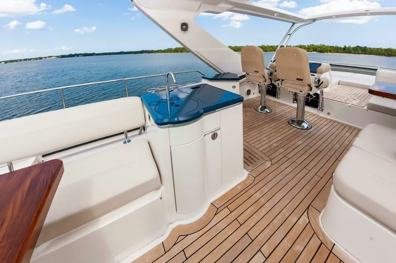 Slide: The Image of Luxurious 2015 Sea Ray L659 Fly yacht interior with elegant seating and wooden flooring. - 18