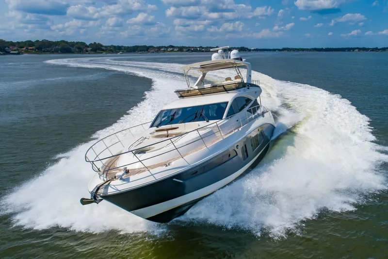 Slide: The Image of 2015 Sea Ray L659 Fly yacht cruising on open water, creating a dynamic wake. - 2