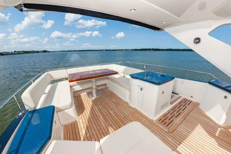 Slide: The Image of Luxurious 2015 Sea Ray L659 Fly yacht deck with seating and ocean view. - 22
