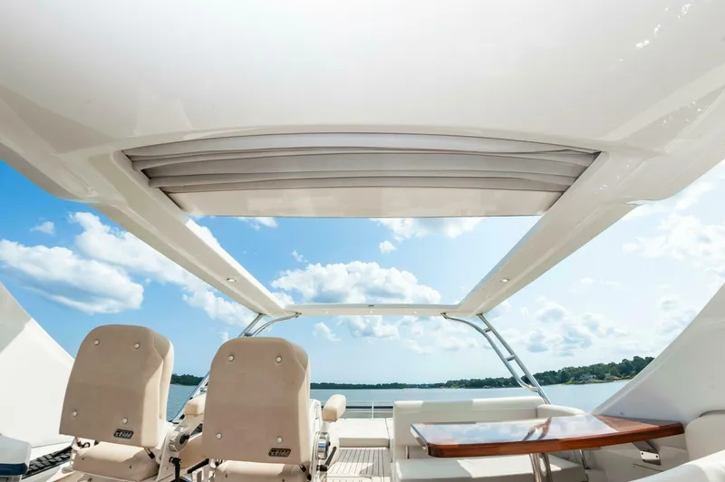 Slide: The Image of Luxurious 2015 Sea Ray L659 Fly yacht interior with open sunroof and scenic water view. - 23