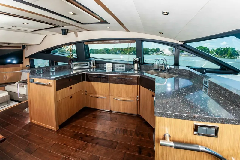 Slide: The Image of Luxurious 2015 Sea Ray L659 Fly yacht kitchen with sleek countertops and panoramic windows. - 34