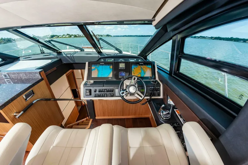 Slide: The Image of Luxurious 2015 Sea Ray L659 Fly yacht cockpit with navigation screens and leather seating. - 40