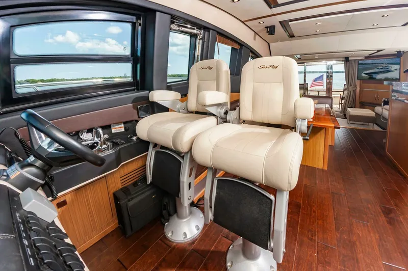 Slide: The Image of Luxurious 2015 Sea Ray L659 Fly yacht interior with plush seating and elegant wood flooring. - 42