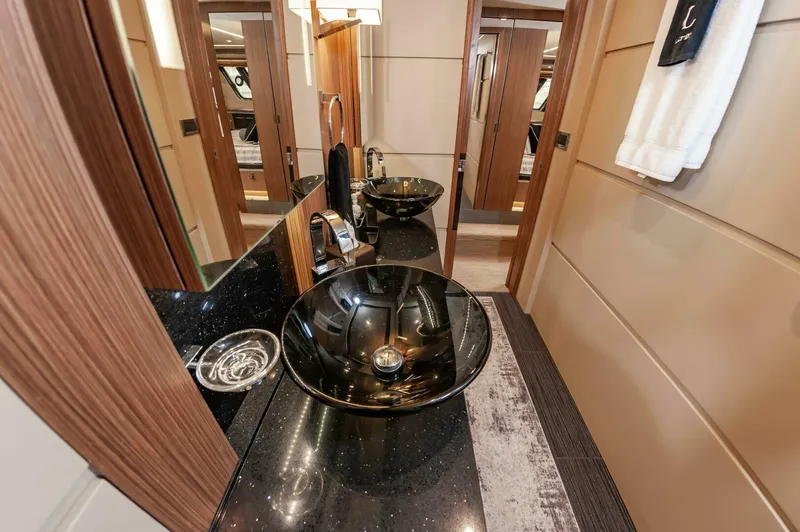 Slide: The Image of Luxurious bathroom interior of 2015 Sea Ray L659 Fly yacht with modern black vessel sinks. - 49