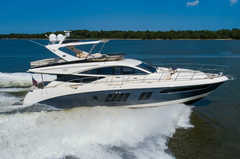 Slide: The Image of 2015 Sea Ray L659 Fly yacht cruising on open water. - 5