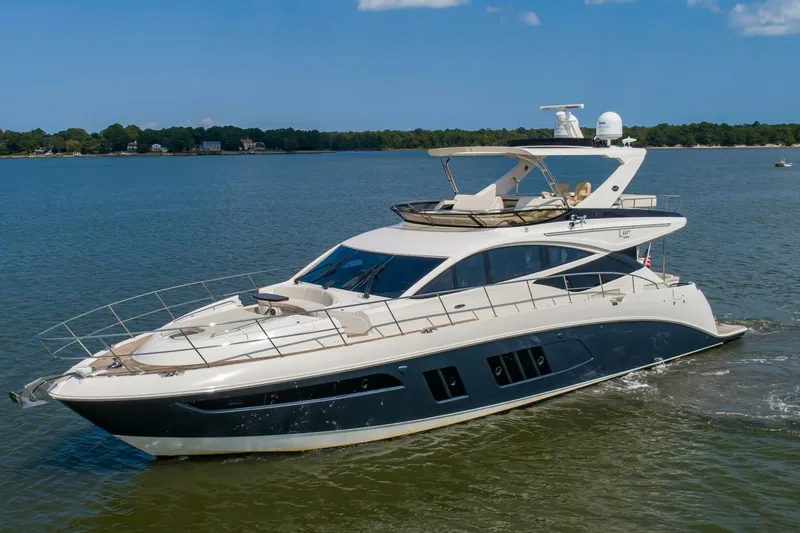 Slide: The Image of 2015 Sea Ray L659 Fly yacht cruising on a serene lake. - 6