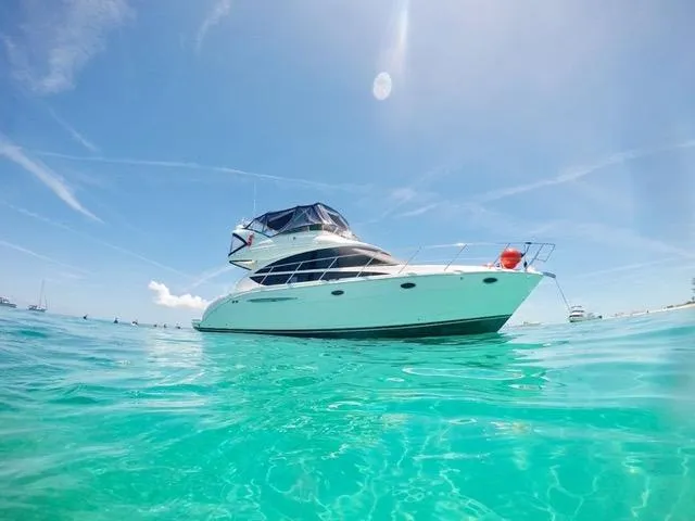Slide: The Image of 2009 Meridian 391 Sedan yacht on clear turquoise water under a bright blue sky. - 0