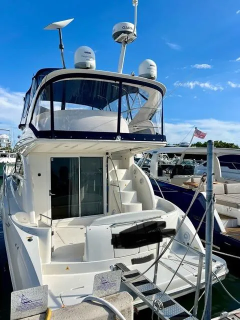 Slide: The Image of 2009 Meridian 391 Sedan yacht docked at marina under clear blue sky. - 1
