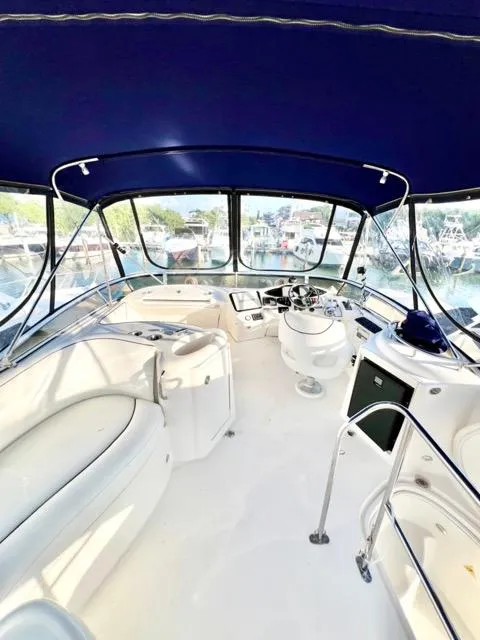 Slide: The Image of 2009 Meridian 391 Sedan yacht interior with blue canopy and white seating. - 10