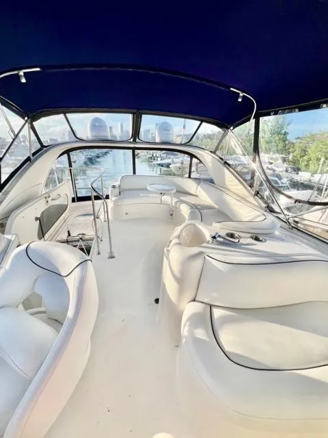Slide: The Image of Interior view of 2009 Meridian 391 Sedan yacht with white seating and blue canopy. - 11