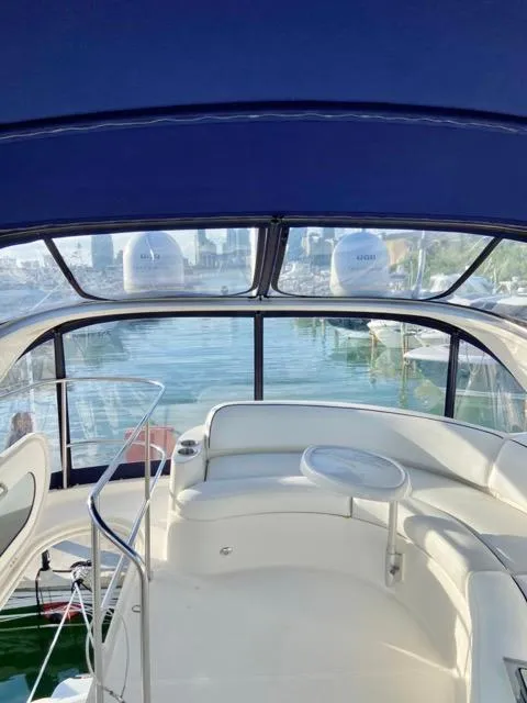 Slide: The Image of 2009 Meridian 391 Sedan yacht interior with seating and table, overlooking marina. - 14