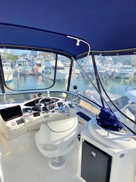 Slide: The Image of 2009 Meridian 391 Sedan yacht cockpit with marina view, featuring modern navigation equipment. - 17