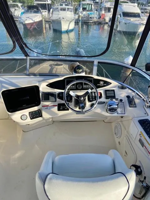Slide: The Image of 2009 Meridian 391 Sedan helm with marina view. - 18