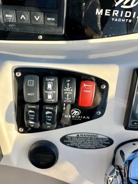Slide: The Image of Control panel of a 2009 Meridian 391 Sedan yacht with various switches and buttons. - 21