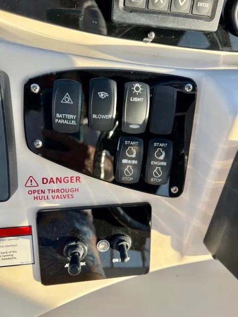 Slide: The Image of Control panel of a 2009 Meridian 391 Sedan boat with various switches and warning labels. - 22