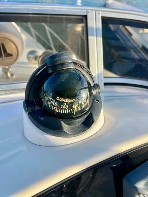 Slide: The Image of Compass on 2009 Meridian 391 Sedan boat dashboard, reflecting sunlight. - 26