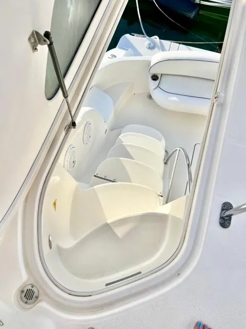 Slide: The Image of 2009 Meridian 391 Sedan boat interior with white seating and steps. - 29