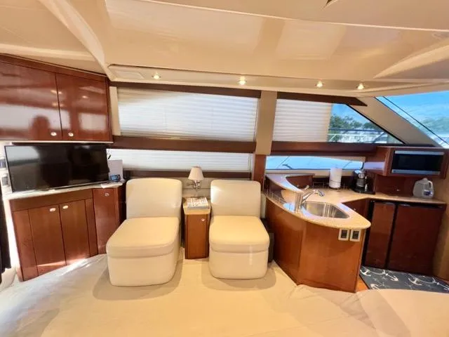 Slide: The Image of Luxurious interior of 2009 Meridian 391 Sedan yacht with modern furnishings and kitchen area. - 34