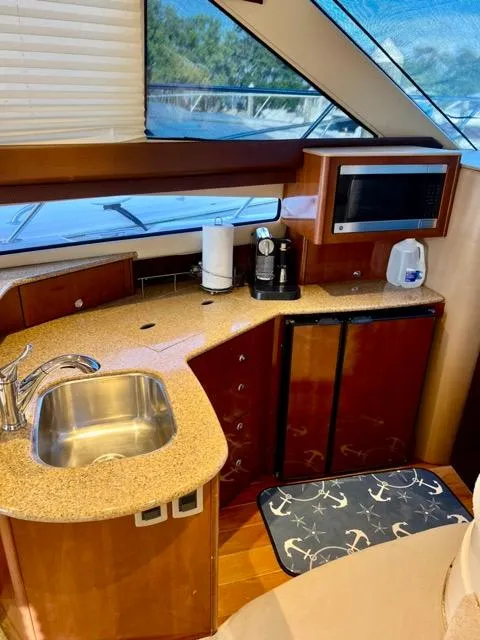 Slide: The Image of 2009 Meridian 391 Sedan yacht kitchen with sink, microwave, and coffee maker. - 37