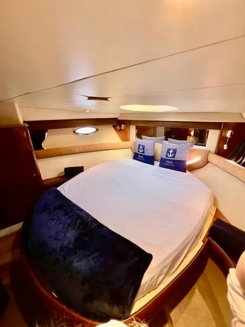 Slide: The Image of Luxurious 2009 Meridian 391 Sedan yacht bedroom with cozy bedding and nautical decor. - 44