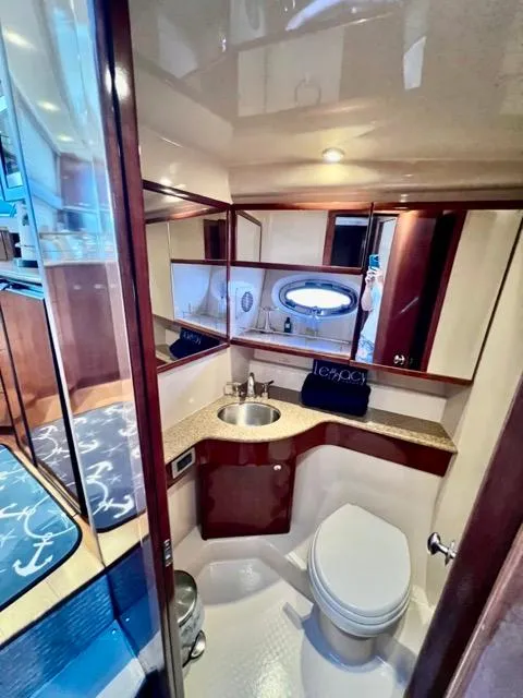 Slide: The Image of Luxurious bathroom in 2009 Meridian 391 Sedan yacht with modern fixtures and wood accents. - 45
