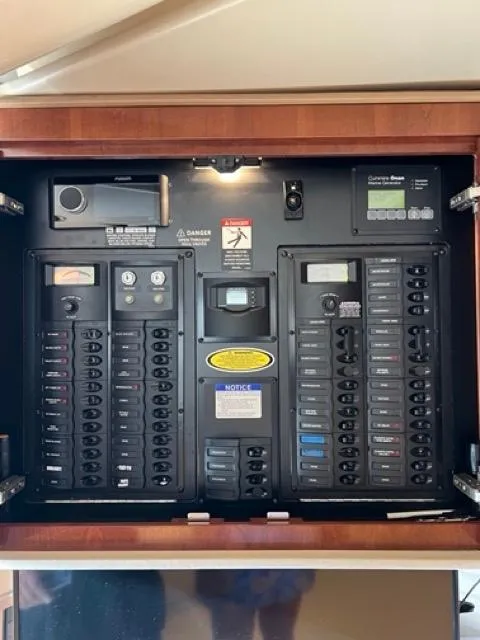 Slide: The Image of Electrical panel of a 2009 Meridian 391 Sedan yacht, featuring various switches and controls. - 48