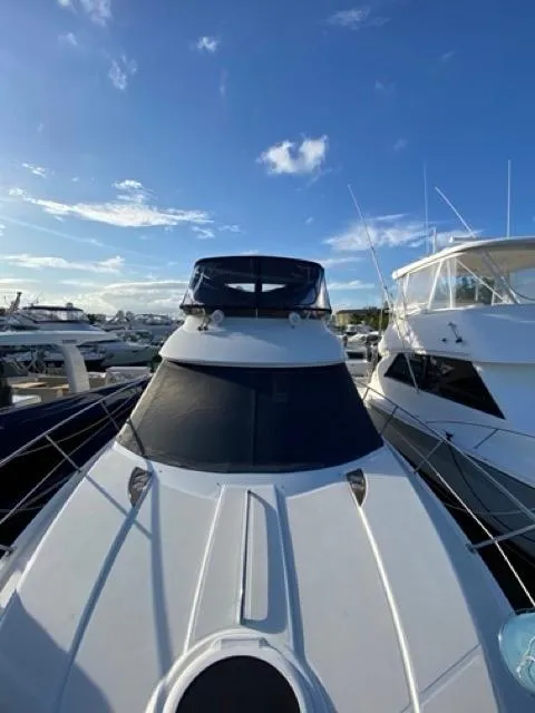 Slide: The Image of 2009 Meridian 391 Sedan yacht docked under a clear blue sky. - 6