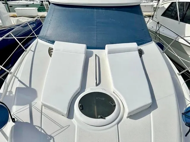 Slide: The Image of 2009 Meridian 391 Sedan yacht deck with sun loungers and circular hatch. - 7