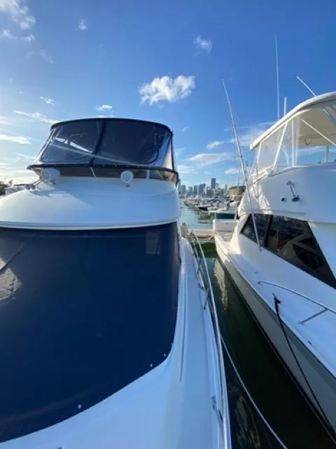 Slide: The Image of 2009 Meridian 391 Sedan yacht docked at marina with city skyline in background. - 8