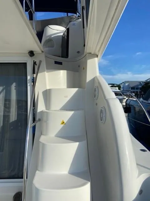 Slide: The Image of Staircase on 2009 Meridian 391 Sedan yacht under clear blue sky. - 9