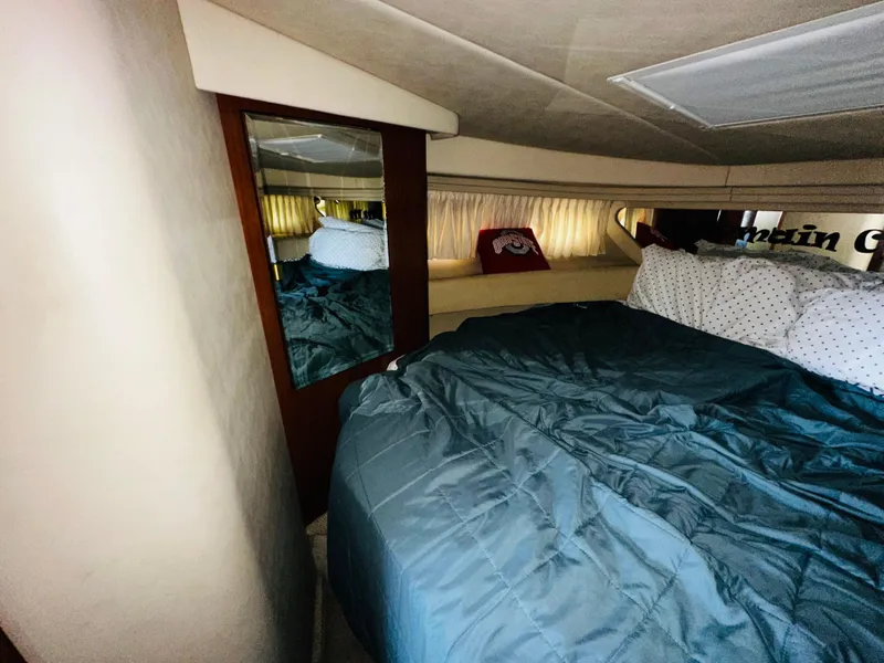 Slide: The Image of Cozy cabin interior of 2002 Sea Ray 380 Sundancer with bed and mirror. - 12