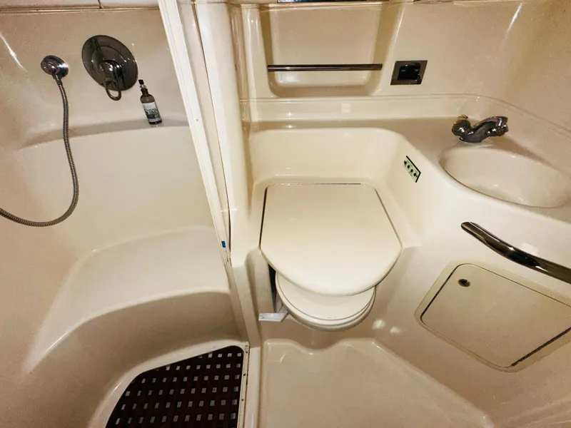 Slide: The Image of 2002 Sea Ray 380 Sundancer bathroom with shower, toilet, and sink. - 13