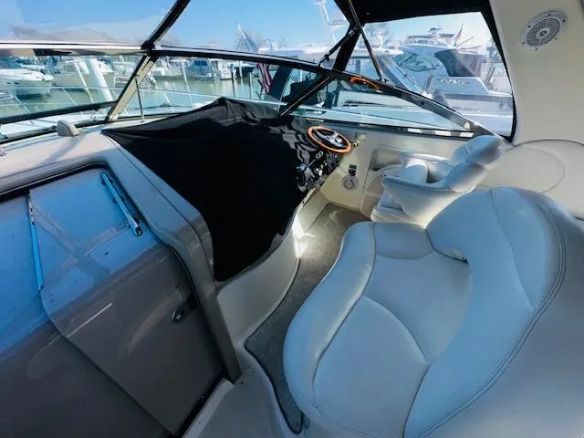 Slide: The Image of Interior of 2002 Sea Ray 380 Sundancer yacht with plush seating and helm. - 4