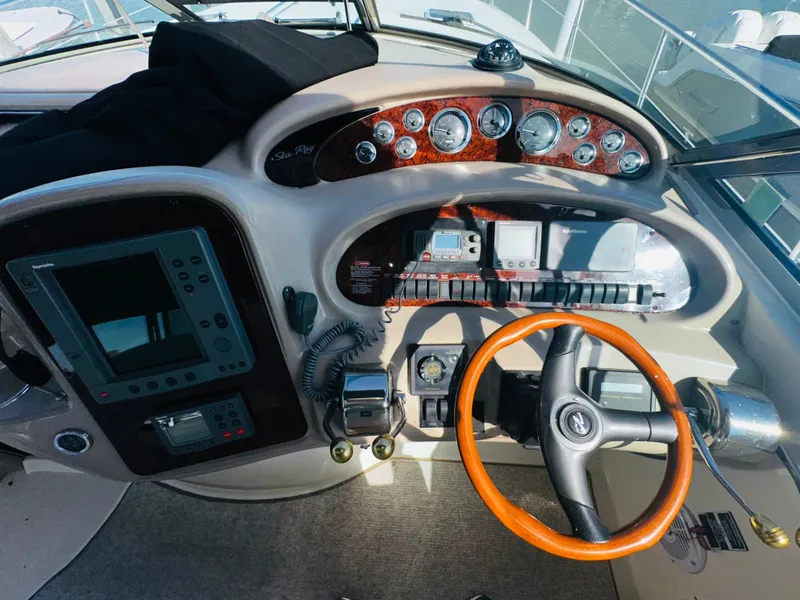 Slide: The Image of 2002 Sea Ray 380 Sundancer helm with wood accents and navigation instruments. - 5