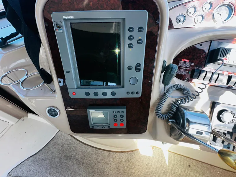 Slide: The Image of Control panel of 2002 Sea Ray 380 Sundancer with navigation equipment and controls. - 6