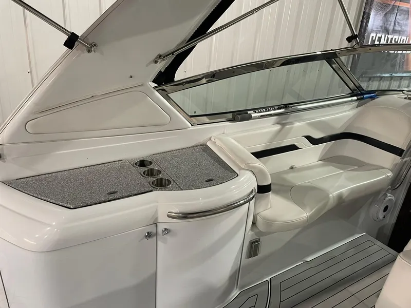 Slide: The Image of 2006 Formula 330 Sun Sport boat interior with seating and cup holders. - 13