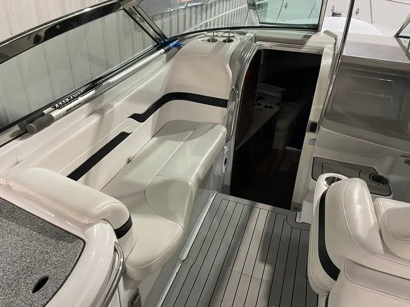 Slide: The Image of 2006 Formula 330 Sun Sport boat interior with white seating and cabin entrance. - 14