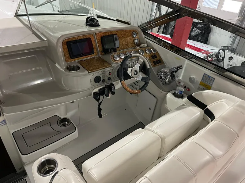 Slide: The Image of 2006 Formula 330 Sun Sport boat interior with steering wheel and control panel. - 16