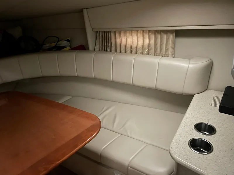 Slide: The Image of 2006 Formula 330 Sun Sport cabin interior with beige seating and wooden table. - 20
