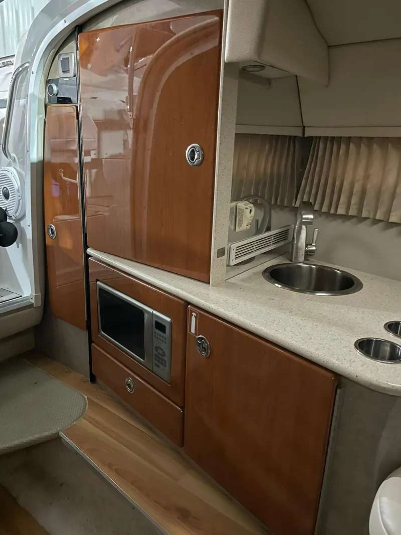 Slide: The Image of 2006 Formula 330 Sun Sport boat interior with kitchenette, microwave, and sink. - 23