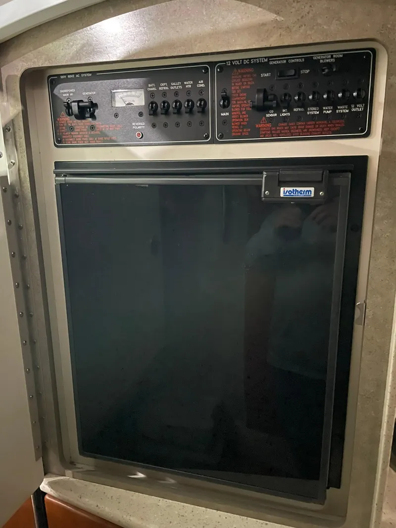 Slide: The Image of Control panel and refrigerator in 2006 Formula 330 Sun Sport boat interior. - 24