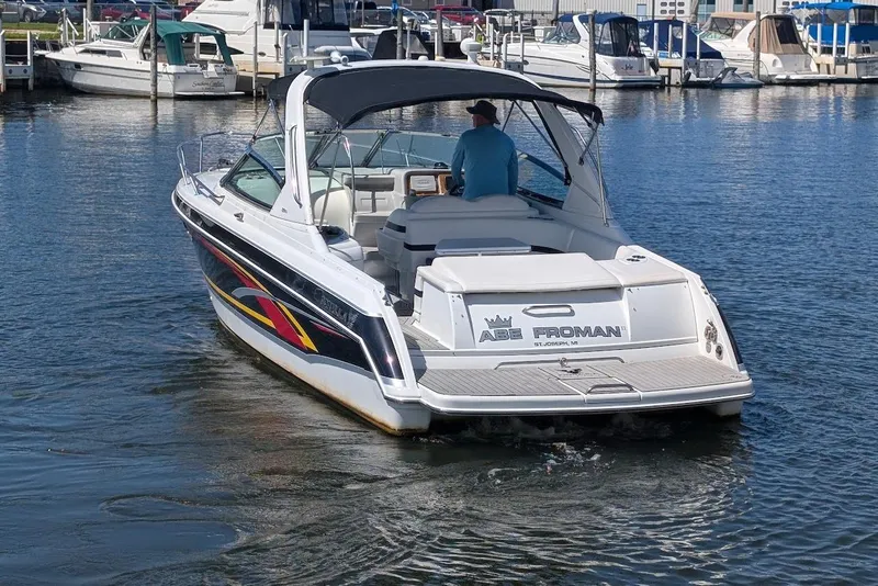 Slide: The Image of 2006 Formula 330 Sun Sport boat cruising in a marina, featuring colorful graphics. - 3