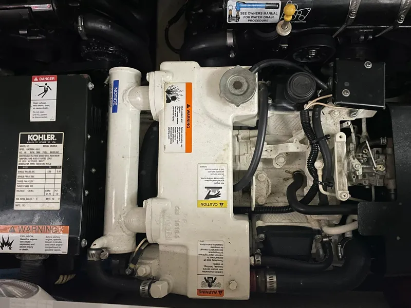 Slide: The Image of Engine compartment of a 2006 Formula 330 Sun Sport boat, featuring a Kohler generator. - 32