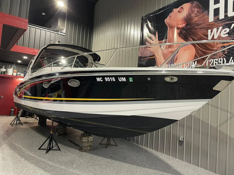 Slide: The Image of 2006 Formula 330 Sun Sport boat displayed indoors on stands. - 5