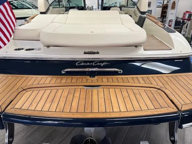 Slide: The Image of 2025 Chris-Craft Sportster 25 boat with teak deck and cushioned seating. - 3